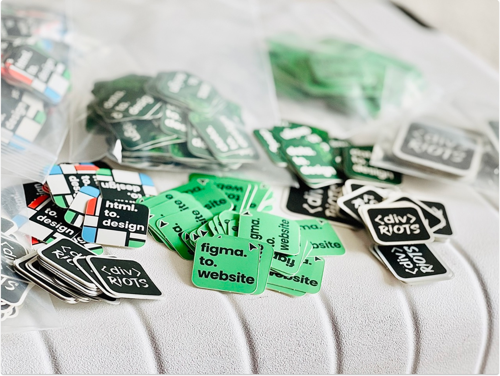 Photo of divRIOTS, html.to.design and figma.to.website branded stickers.